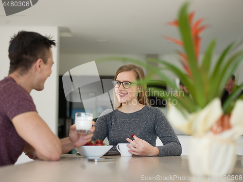 Image of couple enjoying morning coffee and strawberries