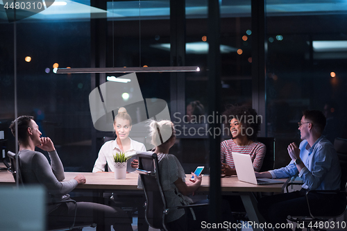 Image of Multiethnic startup business team in night office