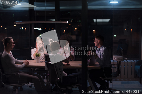 Image of Multiethnic startup business team in night office