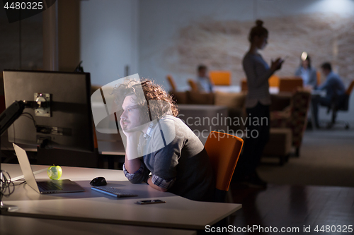 Image of businessman relaxing at the desk