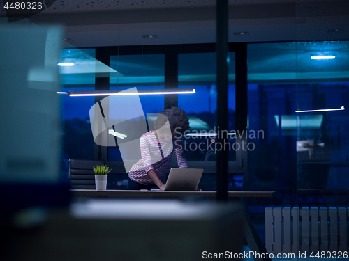 Image of black businesswoman using a laptop in startup office