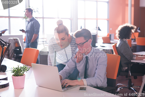 Image of Two Business People Working With laptop in office