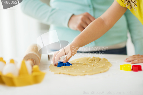 Image of mother and daughter making cookies at home