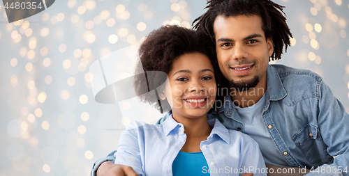 Image of happy african american couple hugging