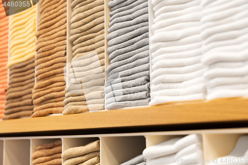 Image of close up of shelves with clothes at clothing store