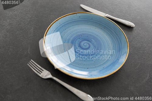 Image of close up of plate, fork and knife on table