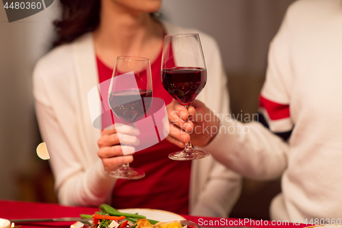 Image of close up of couple drinking red wine on christmas