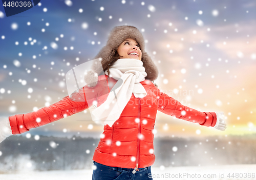 Image of happy woman in winter fur hat outdoors