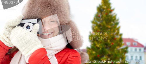 Image of woman with camera over christmas tree in tallinn