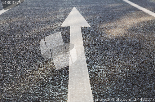 Image of close up of arrow road surface marking on asphalt