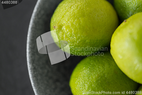 Image of close up of whole limes in bowl