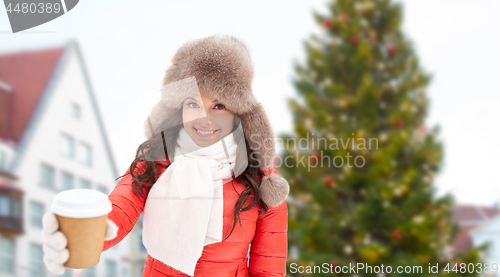 Image of woman with coffee over christmas tree in tallinn