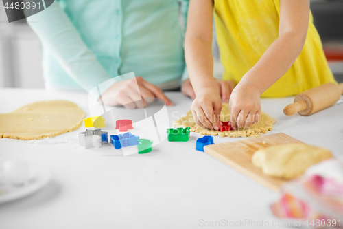 Image of mother and daughter making cookies at home