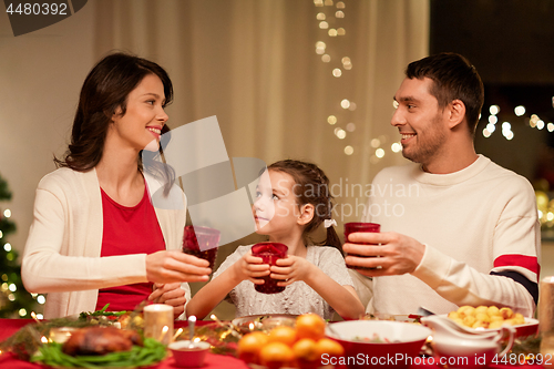Image of happy family having christmas dinner at home