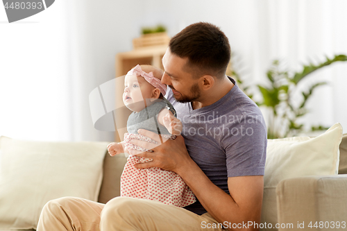 Image of father with little baby girl at home