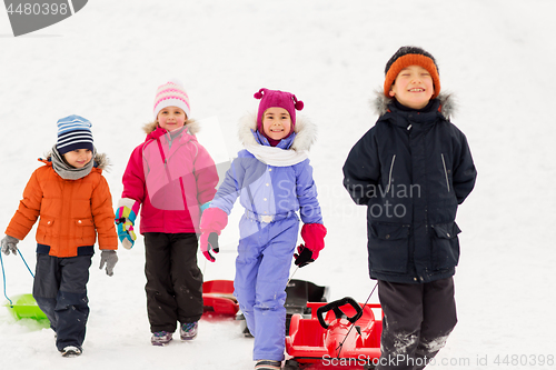 Image of happy little kids with sleds in winter