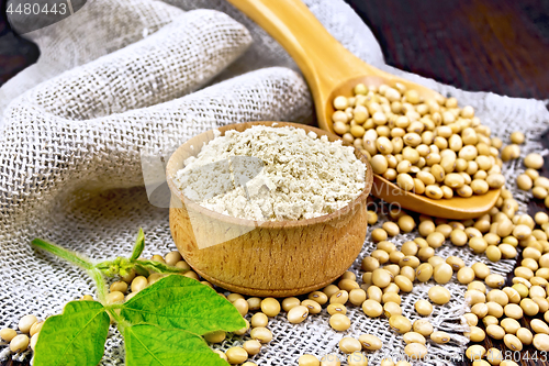 Image of Flour soy in bowl with soybeans on dark board