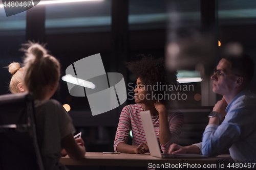 Image of Multiethnic startup business team in night office