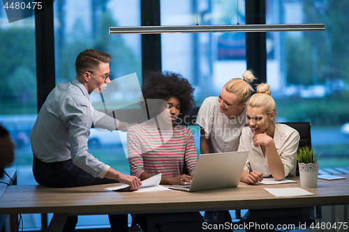 Image of Multiethnic startup business team in night office