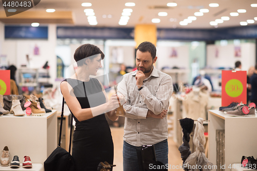 Image of couple chooses shoes At Shoe Store