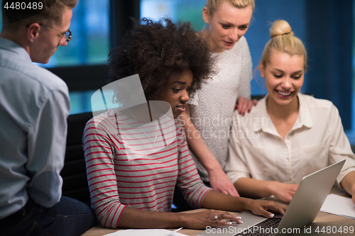 Image of Multiethnic startup business team in night office