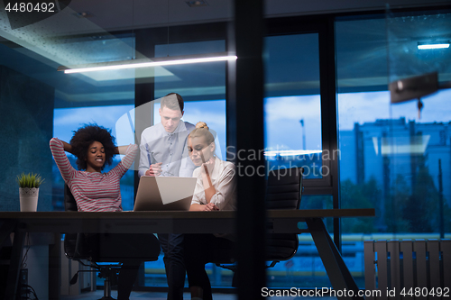 Image of Multiethnic startup business team in night office