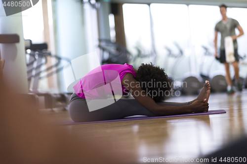 Image of african american woman exercise yoga in gym