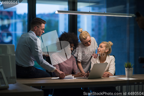 Image of Multiethnic startup business team in night office