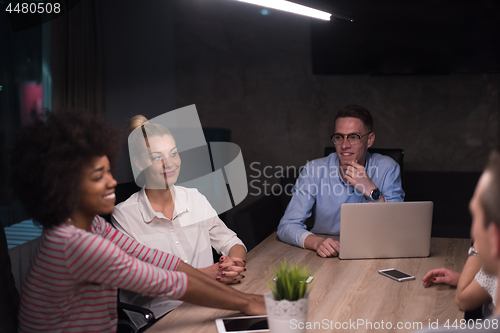 Image of Multiethnic startup business team in night office