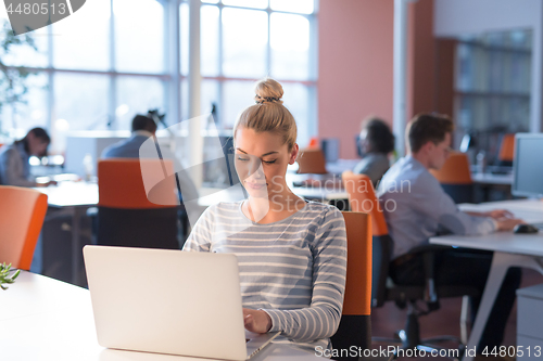 Image of businesswoman using a laptop in startup office