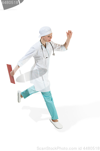 Image of Beautiful young woman in white coat running at studio. Full length studio shot isolated on white.