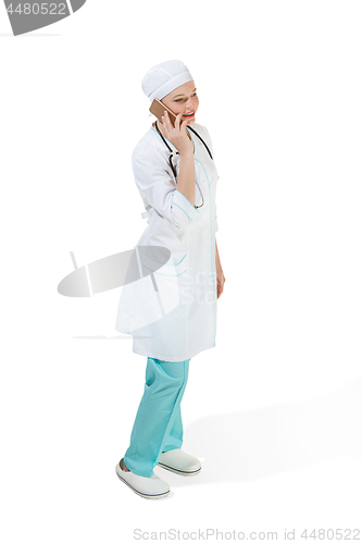 Image of Beautiful young woman in white coat posing at studio. Full length studio shot isolated on white.