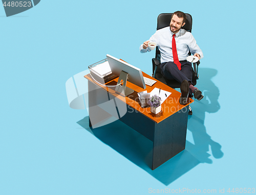 Image of Shot from above of a stylish business man working on a laptop.