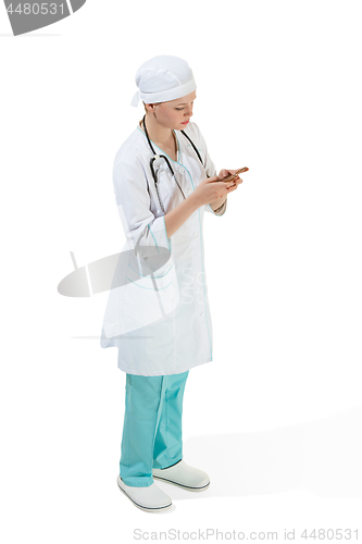 Image of Beautiful young woman in white coat posing at studio. Full length studio shot isolated on white.