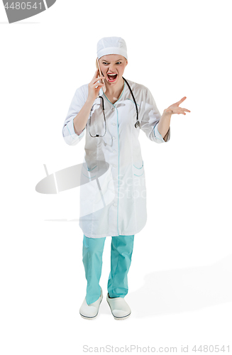 Image of Beautiful young woman in white coat posing at studio. Full length studio shot isolated on white.