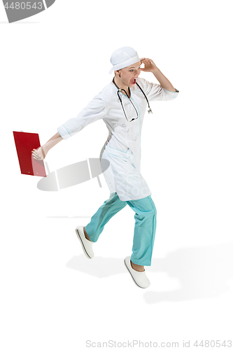 Image of Beautiful young woman in white coat running at studio. Full length studio shot isolated on white.