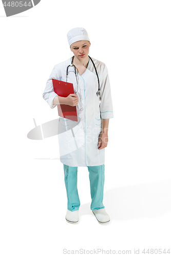 Image of Beautiful young woman in white coat posing at studio. Full length studio shot isolated on white.