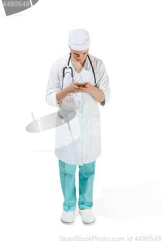 Image of Beautiful young woman in white coat posing at studio. Full length studio shot isolated on white.