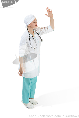 Image of Beautiful young woman in white coat posing at studio. Full length studio shot isolated on white.