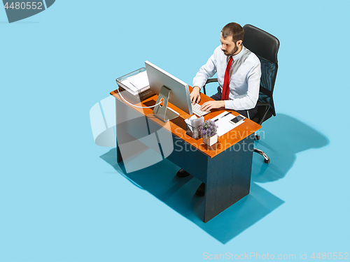 Image of Shot from above of a stylish business man working on a laptop.