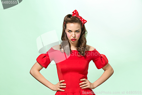 Image of Beautiful young woman with pinup make-up and hairstyle. Studio shot on white background