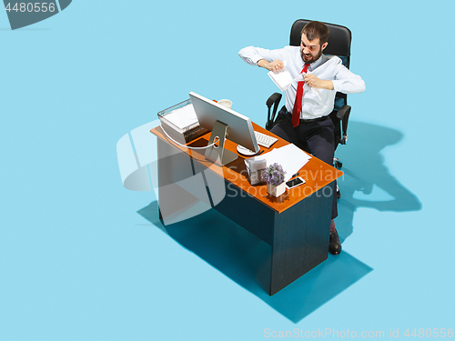 Image of Shot from above of a stylish business man working on a laptop.