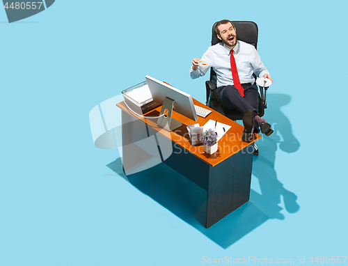 Image of Shot from above of a stylish business man working on a laptop.