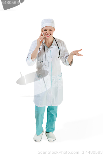 Image of Beautiful young woman in white coat posing at studio. Full length studio shot isolated on white.