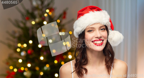 Image of woman with red lipstick in santa hat on christmas