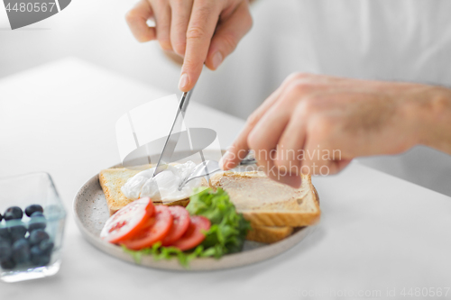 Image of close up of man having toasts for breakfast