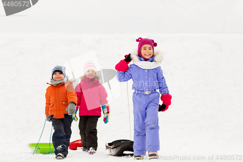 Image of happy little kids with sleds in winter