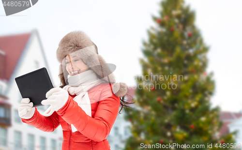 Image of woman with tablet pc over christmas tree