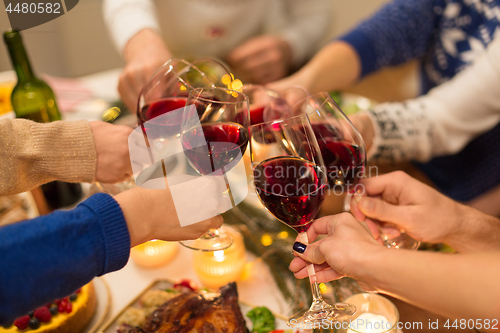 Image of close up of friends with wine celebrate christmas