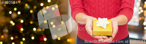 Image of close up of woman hands holding christmas gift